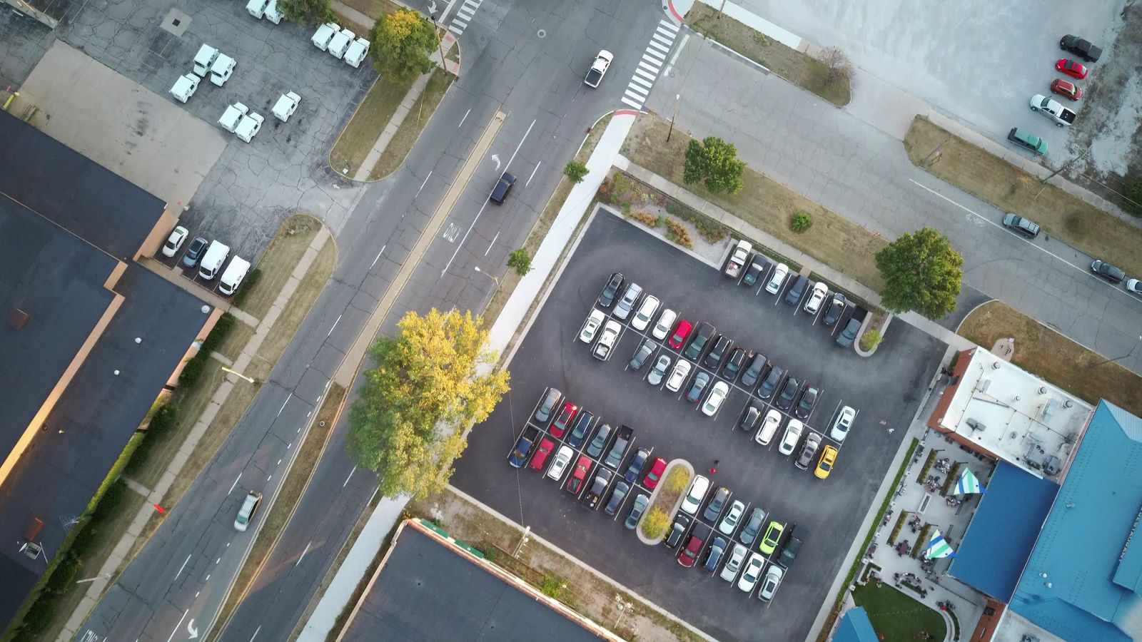 Aerial view of a striped parking lot with landscaped islands